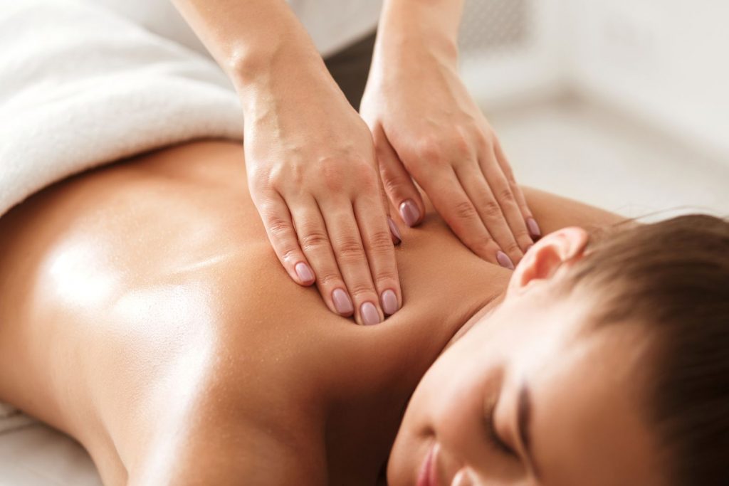 Image of happy woman receiving a relaxing massage